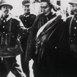 Tibetan man being escorted ...