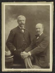 Charles F. McKim and Wm. R. Mead. McKim seated on bench, Mead standing behind to L.