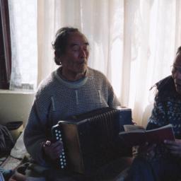 Two men, one singing and on...