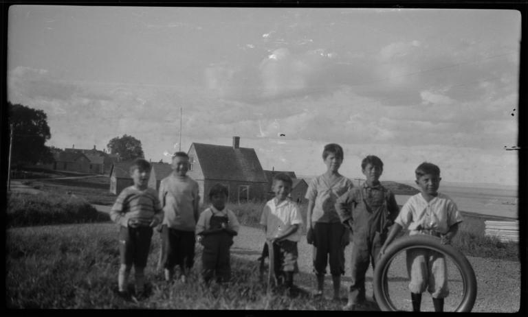 Group of Children Posing in front of a Village