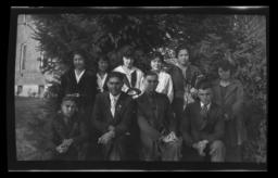 Group of Young People Posing in front of Foliage