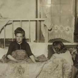 Woman in Bed with Two Children